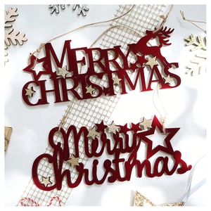 Close-up of red Merry Christmas reindeer ornaments with gold star details and festive ribbons