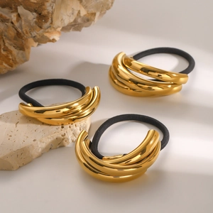Detailed close-up of golden metal hair ties with high elasticity black bands