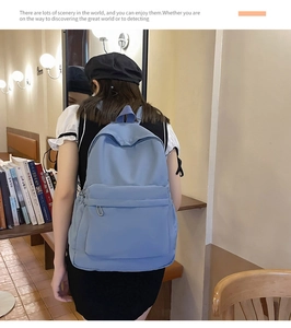 Detail of light blue large capacity backpack with front pocket and nylon strap texture