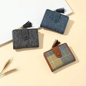 Short minimalist women's tassel wallets in various denim and plaid textures with snap closure