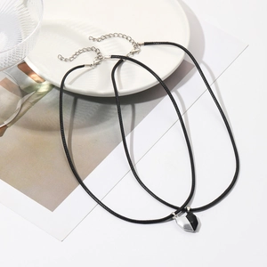 Close-up of magnetic heart pendants on rainbow bead necklaces for couples set