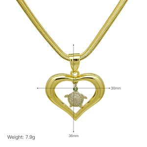 Detail of gold heart pendant with turtle design including dimensions 30mm by 36mm