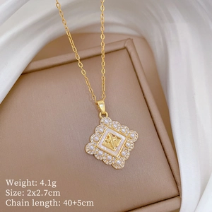 Macro view of gold cross pendant with mother of pearl and pearls on a jewelry box