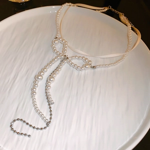 Elegant double-layered pearl necklace with a chic bowknot and silver metallic details