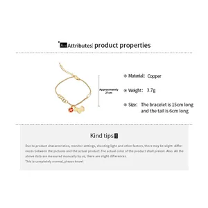 Detailed view of a gold-tone copper bracelet with a red coin and a small dog silhouette charm