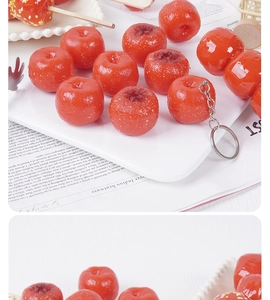 Detailed view of realistic red PVC hawthorn pendant with glossy sugar coating texture