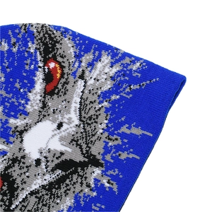 Detail of blue eagle jacquard knit beanie featuring intricate textured pattern and vibrant colors