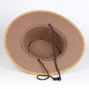 Detail of western cowboy hat interior showing woven brim, metal eyelet and wind rope