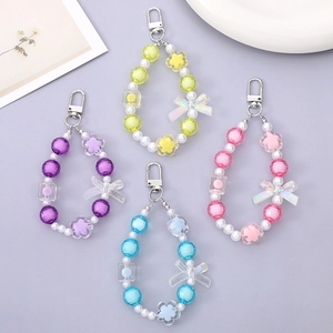 Close-up of DIY colorful resin beaded keychains with metal lobster clasps in four pastel shades