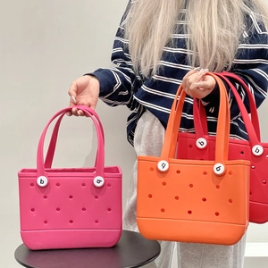 Detailed close-up of colorful EVA beach tote bags with signature perforated design and rivets
