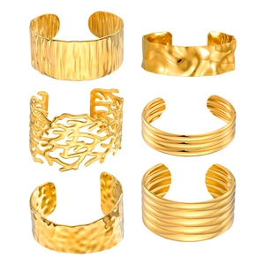 Set of six layered gold-plated open bangles featuring hammered and coral textures