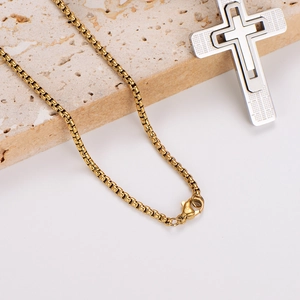Men's two-tone hollow cross pendant necklace on a gold box chain with mesh texture