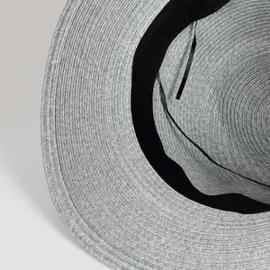 Close-up of light blue woven straw hat showing detailed texture and black inner sweatband