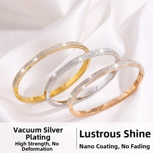 Close-up of gold, silver, and rose gold bracelets with double-row crystals on silk