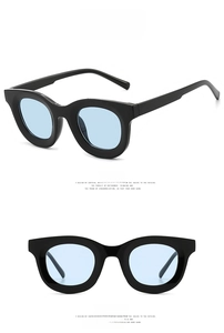 Detail view showing front and side profile of black sunglasses with light blue lenses