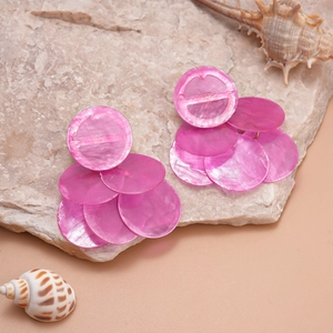Pink tiered geometric shell-like disc earrings on a natural stone base for beach vacation