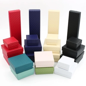 Detailed view of textured jewelry gift boxes in multiple colors and square shapes