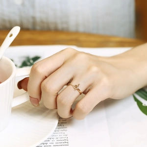 Minimalist gold toggle clasp chain ring for women shown in a lifestyle setting
