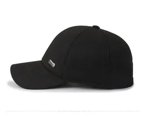 Detailed side view of a black winter wool baseball cap with metallic logo and curved brim