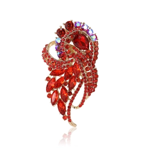 Luxurious flower brooch with large red crystals and glittering rhinestones in gold setting