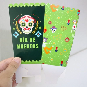 Boîtes à pop-corn Día de Muertos avec têtes de mort colorées et motifs festifs