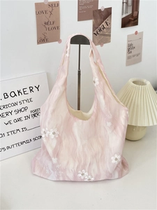 Detailed texture of pink marble canvas tote bag featuring white 3D floral embroidery