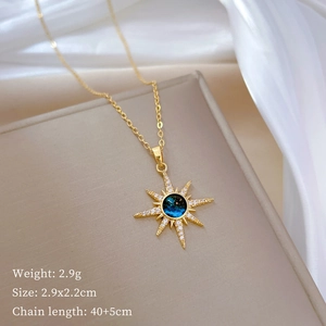 Detail of titanium star pendant necklace with blue gem and dimensions of 2.9x2.2cm