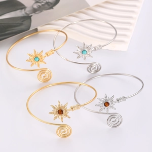Detail of four-piece adjustable arm cuff set featuring sun motifs and turquoise accents