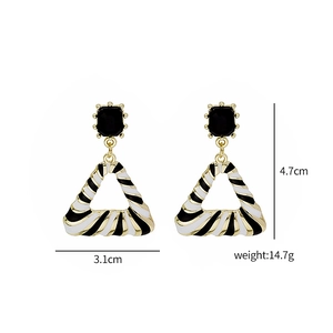 Detail of geometric drop earrings with black white stripes and 4.7cm height measurement