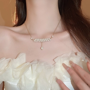 French vintage double-layer pearl necklace with gold chain on model's neck