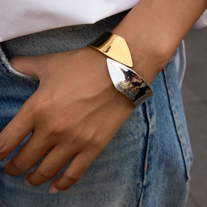 Minimalist 18K gold and silver stainless steel two-tone spring cuff bracelet on wrist