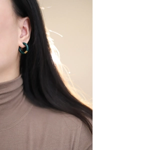 Close-up of model wearing minimalist dark green enamel hoop earring with 18K gold plating