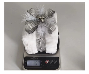 Close-up of white plush Christmas gift box decoration with silver bow weighing 57 grams
