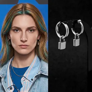 Detail of silver padlock pendant earring featuring a high-polish metallic finish