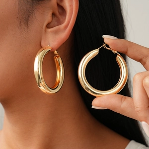 Polished gold geometric hoop earrings with metallic finish for a minimalist commute look