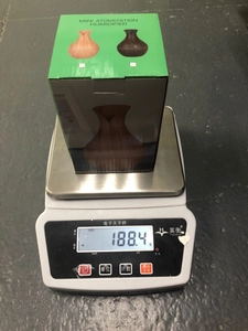 Ultrasonic wood grain humidifier in packaging on a scale showing 188.4g net weight