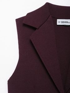 Macro shot of the knitted texture and suit-style lapel on this purple knit vest
