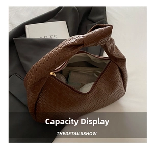 Macro view of woven brown leather hobo bag showing large interior capacity and lining