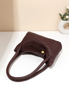 Handwoven dark brown leather tote bag with vintage texture and gold ball ornament