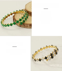 Detail of adjustable 18k gold plated stainless steel cuff with emerald and square zircon