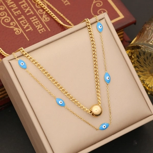 Double-layer gold evil eye necklace with blue enamel charms and a spherical pendant