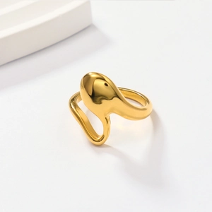 Detail shot of a liquid gold 18k gold plated stainless steel irregular ring on white prop