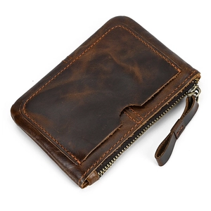 Detail of dark brown leather coin purse showing vintage texture and stitching