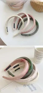 Close-up of handmade embroidered satin headbands featuring delicate floral patterns
