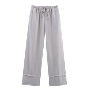 Detail of light gray wide-leg linen pants featuring elastic drawstring waist and soft texture