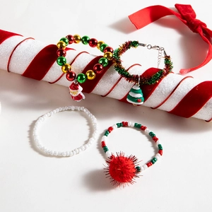 Detail of Christmas bracelet set featuring Santa Claus, reindeer, and bell pendants