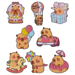 Set of cartoon capybara enamel pins featuring hot air balloon and donut designs