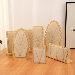 Linen jewelry display stands with bamboo wood bases for necklaces and rings