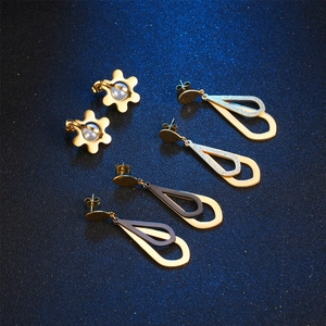 Three pairs of elegant titanium steel earrings with pearl accents and waterdrop shapes