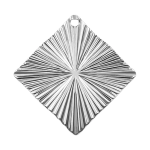 Macro detail of silver rhombic stainless steel pendant with radial sunburst texture